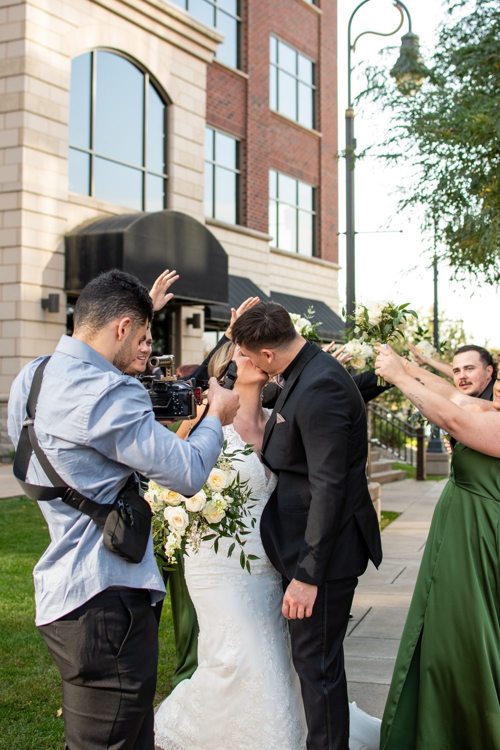 Elias filming a wedding couple during a celebration moment