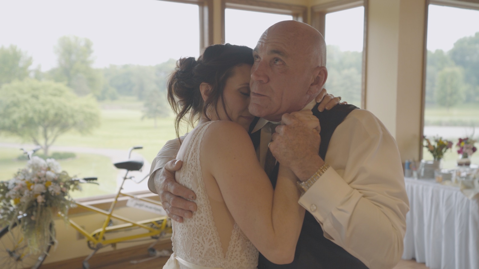 Michaela embracing her father during her wedding reception