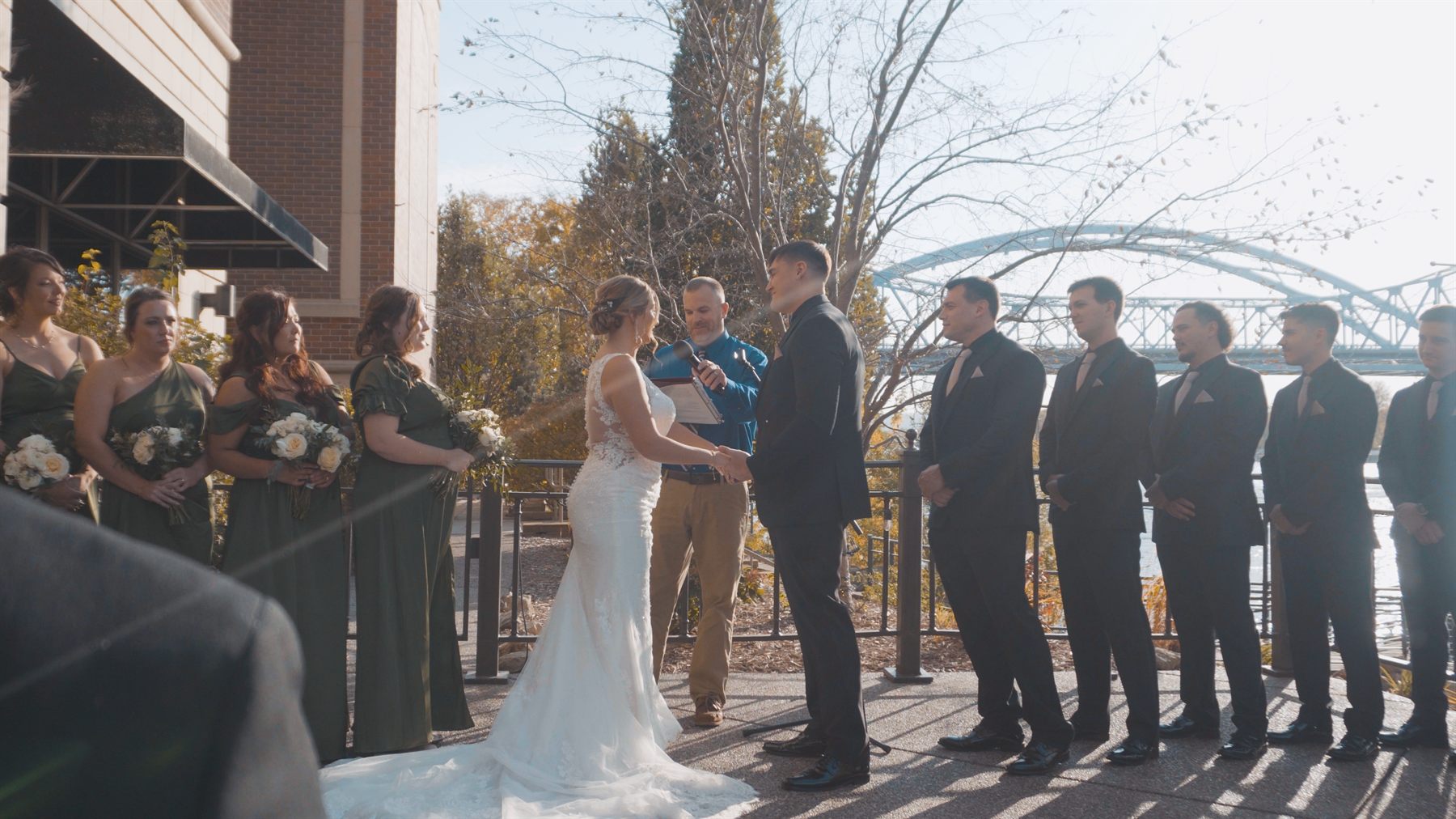 Alex and Emily standing together during their outdoor wedding ceremony